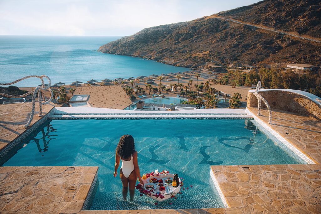 Woman walks into private pool in the Passage to Love Suite at the Calilo Resort in Ios, Greece