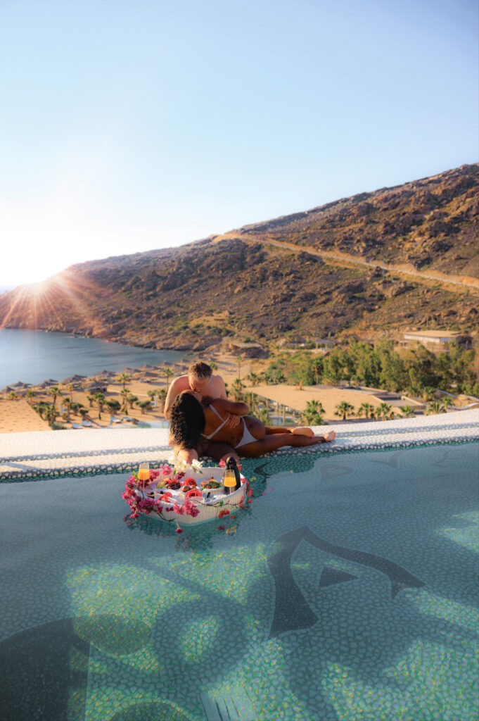 Couple kisses at edge of infinity pool at the Passage to Love Suite at Calilo Resort in Ios, Greece