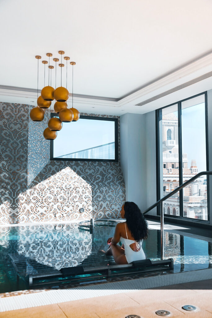 Woman in white swimsuit sitting in a spa hot tub in Cuba