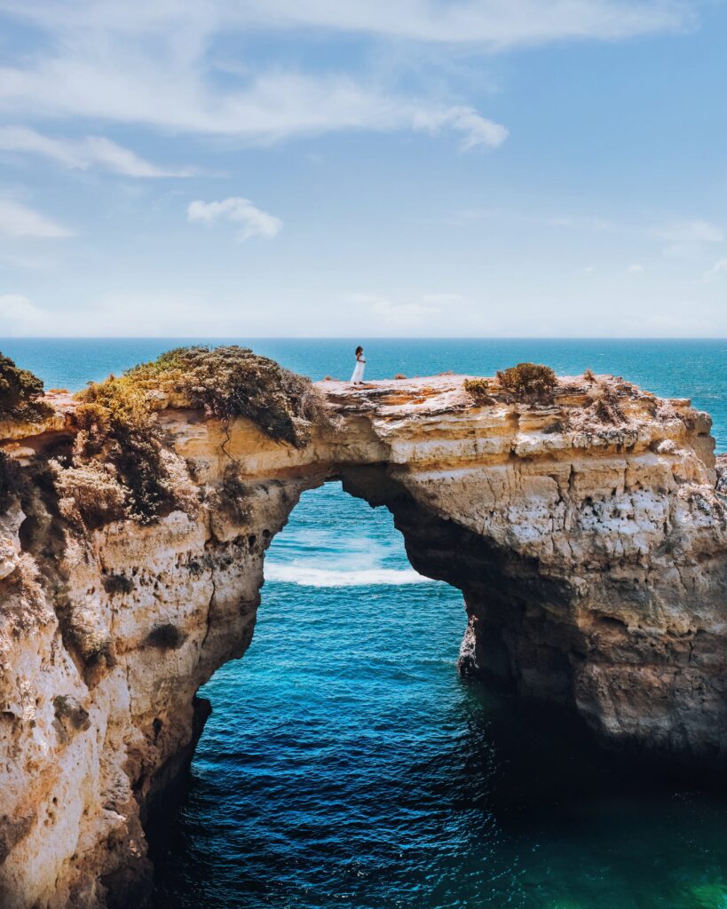 Zee walks along the cliff at Praia da Marinha