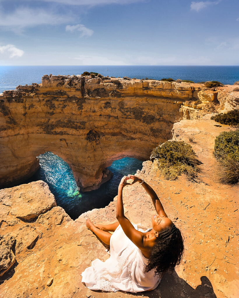 Zee admiring the M Rock aka Cathedral Rock at Praia da Marinha.