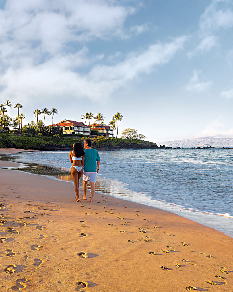 Brett and Zee are walking along the shore on Wailea Beach