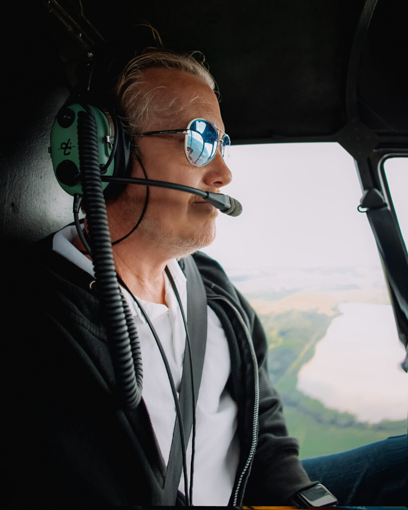 Brett looks out from the helicopter as he and Zee enjoys a private tour around Kauai