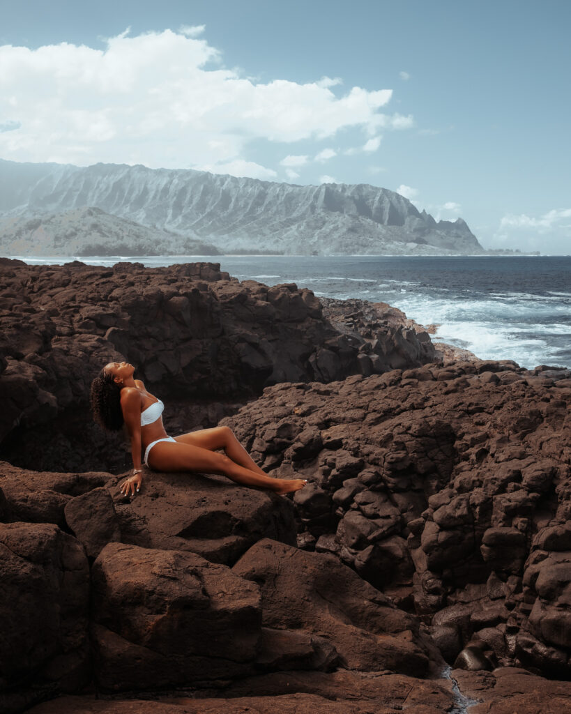 Zee relaxes at Queens Beach while enjoying the sound of the waves crashing against the rocks