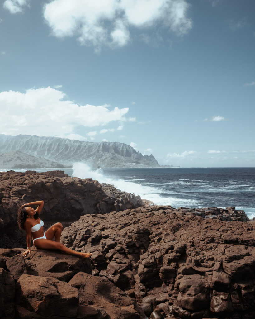 Zee relaxes at Queens Beach while enjoying the sound of the waves crashing against the rocks