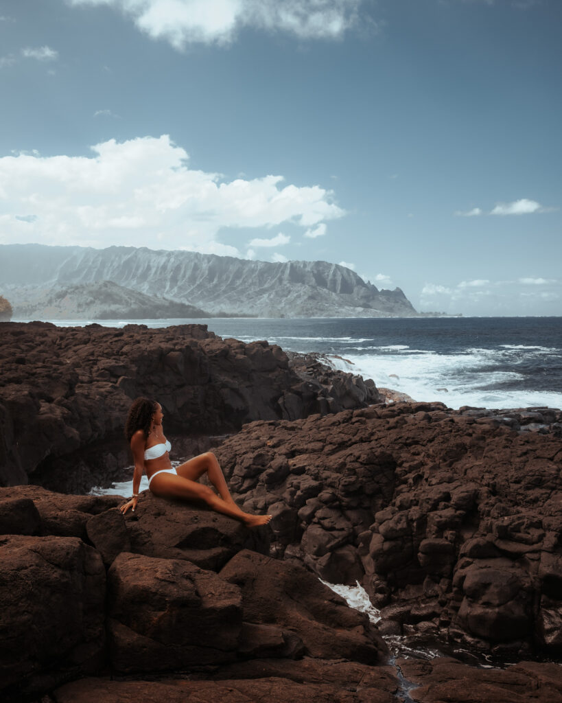 Zee relaxes at Queens Beach while enjoying the sound of the waves crashing against the rocks