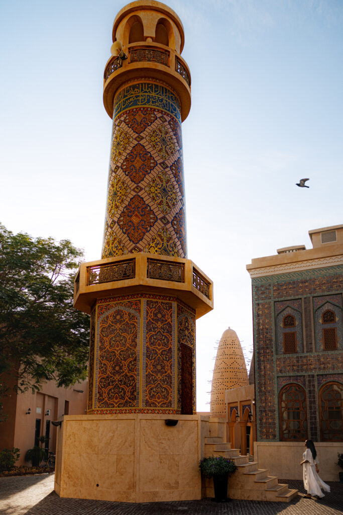 Zee stands at the arch at the Katara Cultural Village