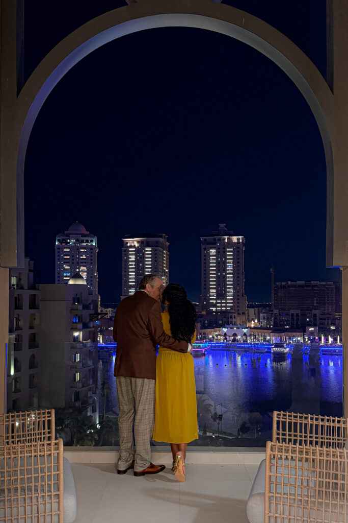 Brett and Zee embrace on there balcony suite at the St. Regis Marsa Arabia, at the Pearl hotel.