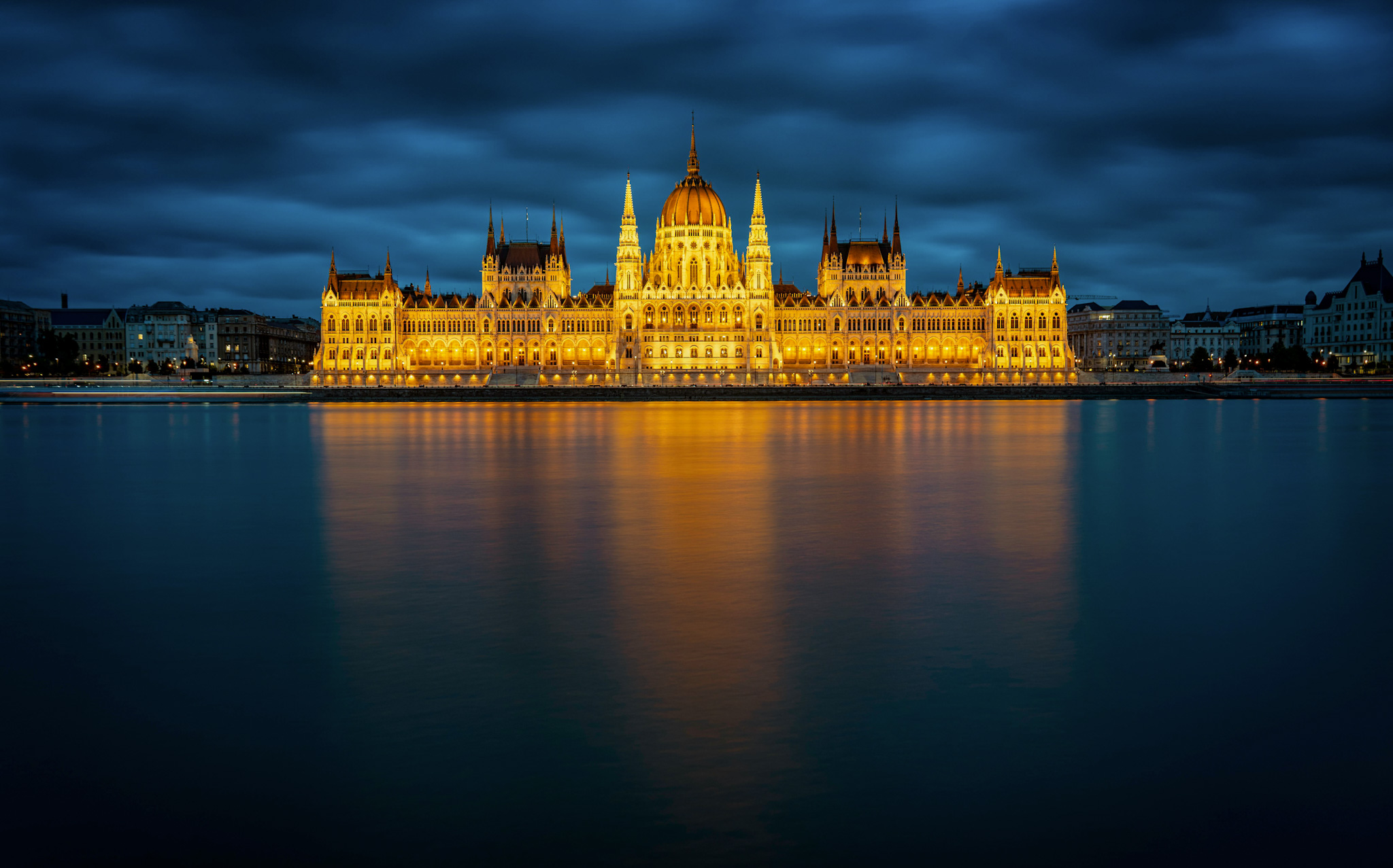 Hungarian Parliament lit up at night on the Danube River in Budapest at Christmas