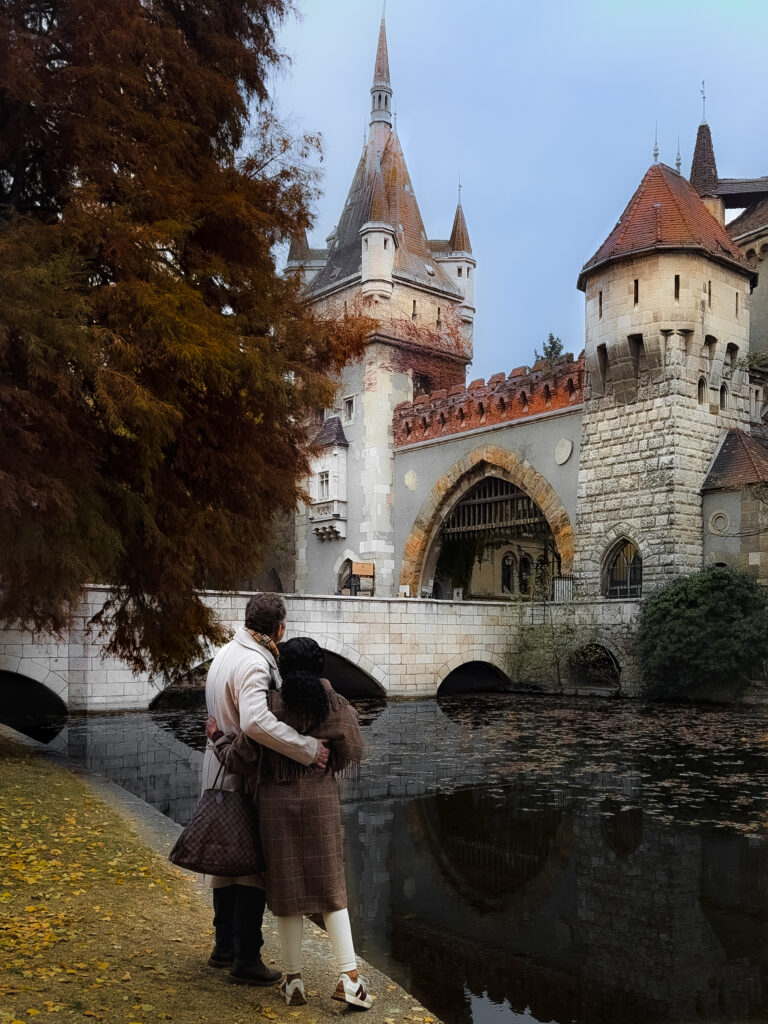 Brett and Zee standing by the water at Vajdahunyad Castle in Budapest at Christmas time.