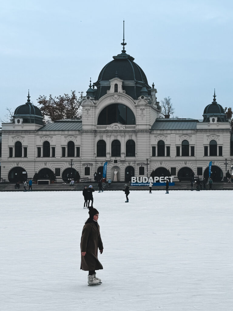 Ice skaters gliding across the City Park Ice Rink (Városligeti Műjégpálya) in Budapest during the Christmas season in Budapest.