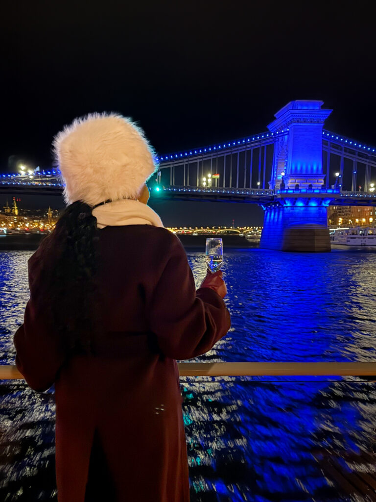 Zee enjoying the night view with a champagne in Budapest at Christmas